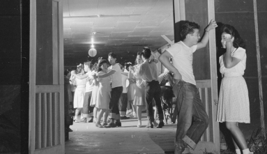 boys and girls in camp at a dance in the barracks